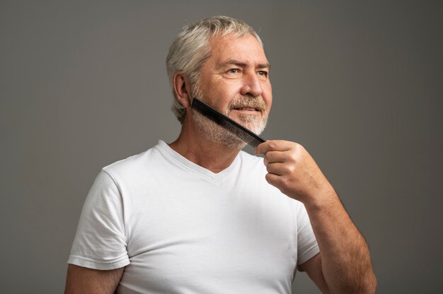 Medium shot man combing beard