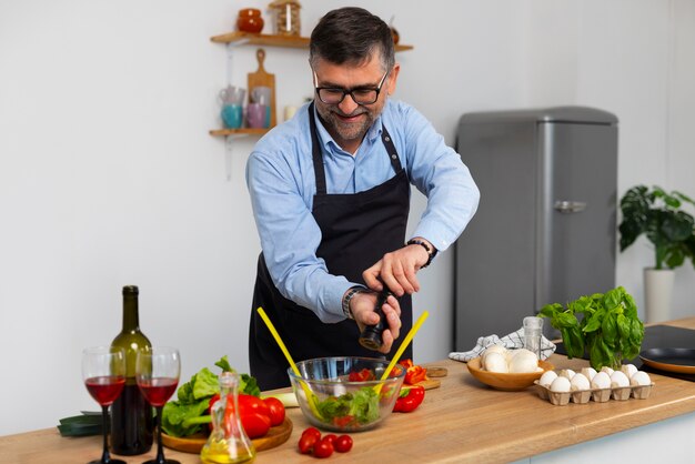 Medium shot man cooking in kitchen