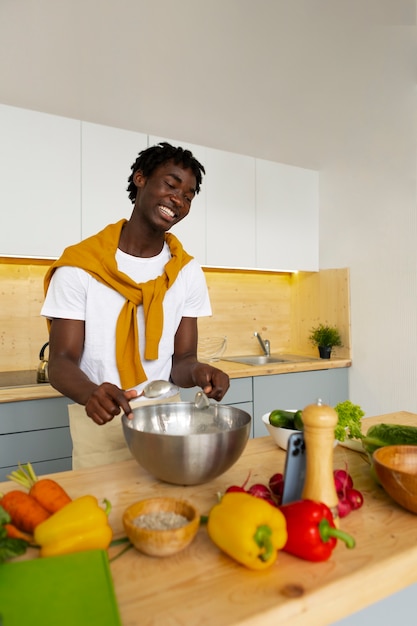 Medium shot man cooking with smartphone