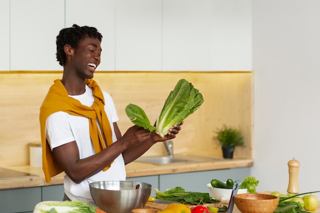 Medium shot man cooking with smartphone