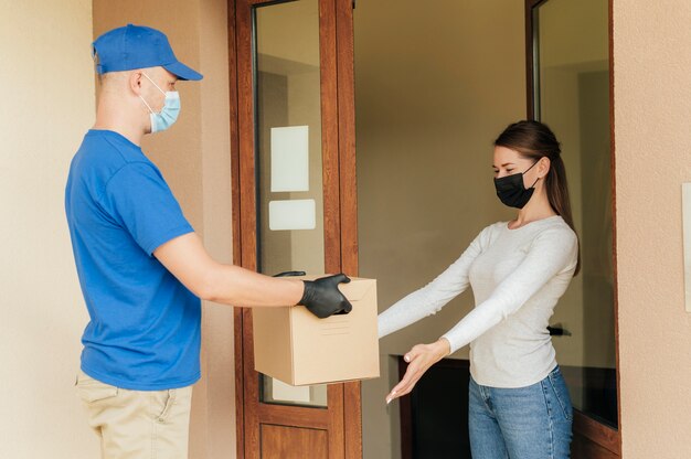 Medium shot man delivering box