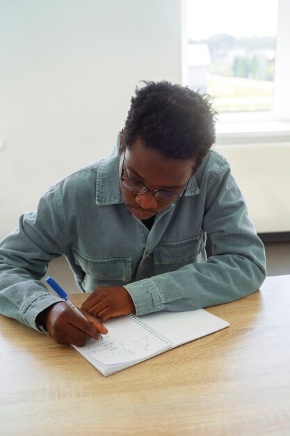 Medium shot man doing math indoors