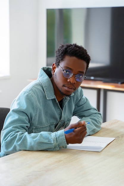 Free photo medium shot man doing math indoors