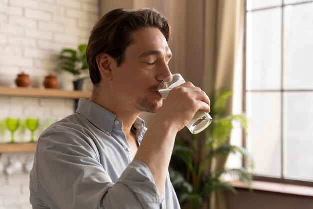 Medium shot man drinking smoothie