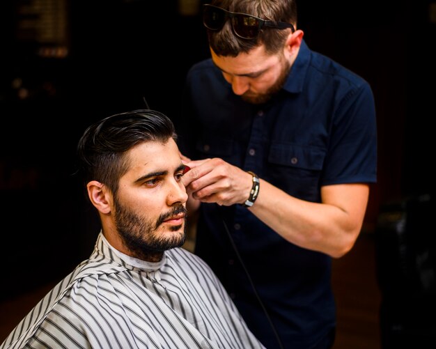 Medium shot of man getting a haircut