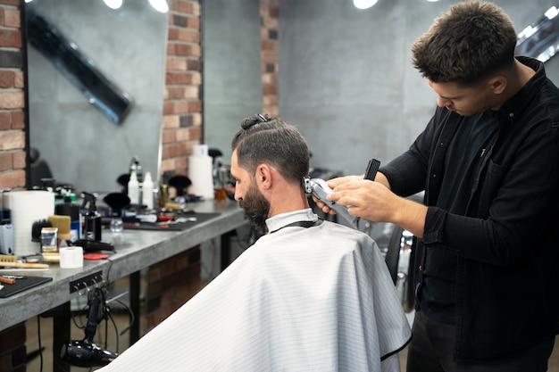 Free photo medium shot man getting haircut