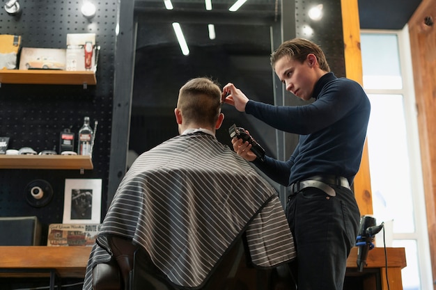 Medium shot man getting haircut