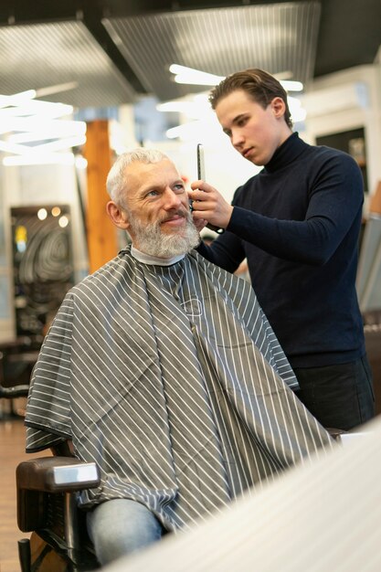 Medium shot man getting haircut