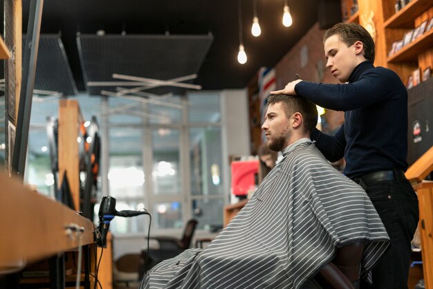 Medium shot man getting haircut