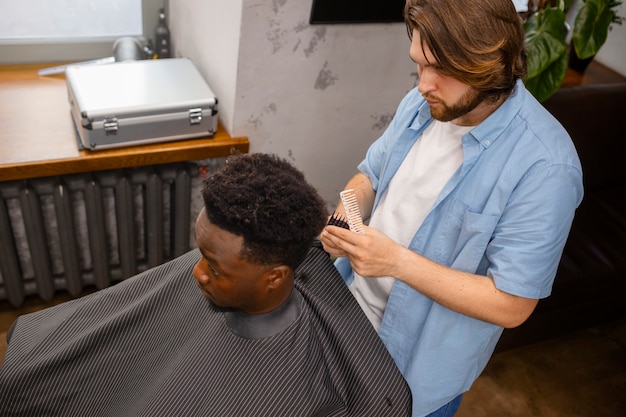 Free photo medium shot man getting a haircut