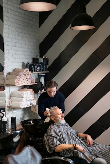 Medium shot man getting his hair washed