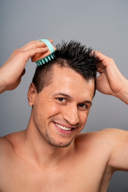 Medium shot man giving himself scalp massage