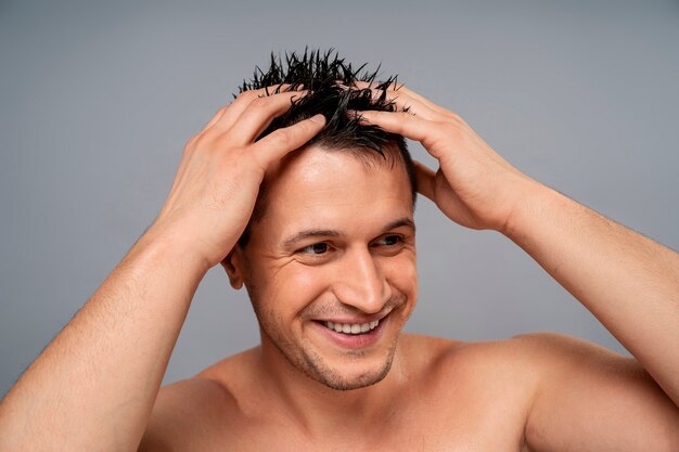 Medium shot man giving himself scalp massage