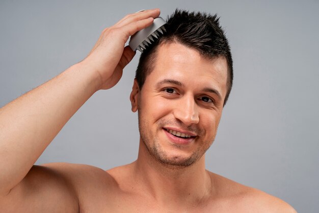 Medium shot man giving himself scalp massage