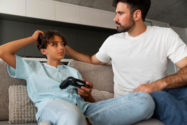 Medium shot man helping boy with lice