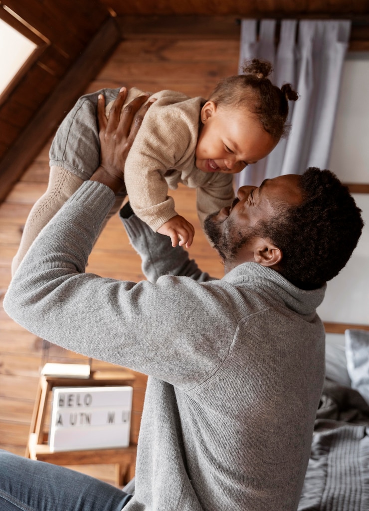 Free Photo medium shot man holding baby