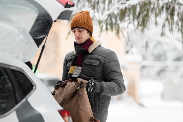 Medium shot man holding backpack