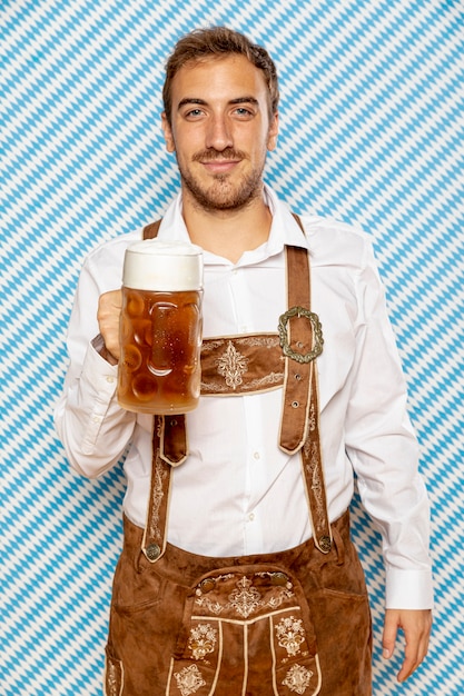 Medium shot of man holding beer pint