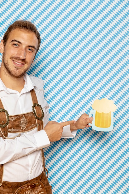 Medium shot of man holding beer pint