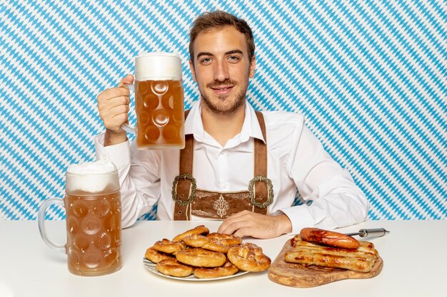 Medium shot of man holding beer pint