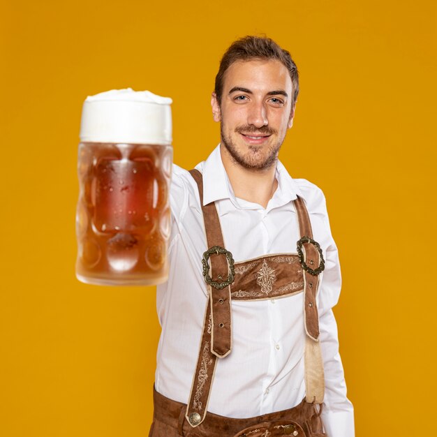 Medium shot of man holding beer pint