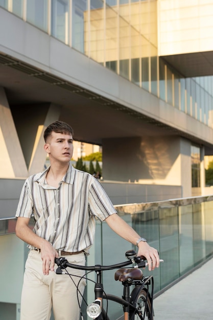 Medium shot man holding bike's handlebars