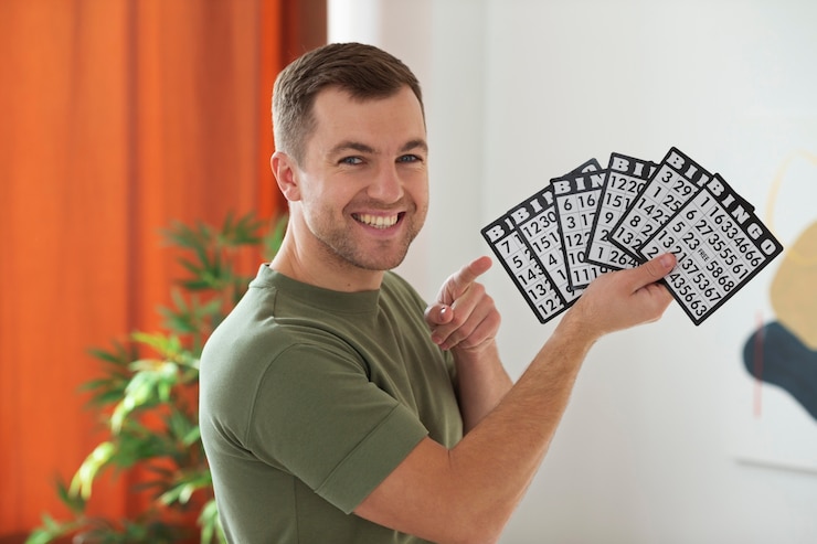 Free Photo medium shot man holding bingo cards