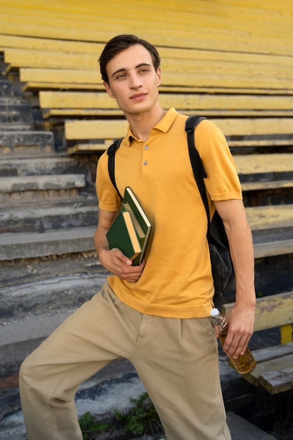 Free photo medium shot man holding books