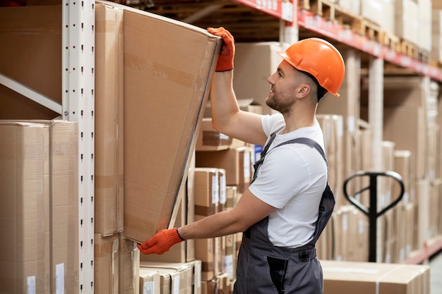 Free photo medium shot man holding box