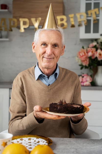 Free photo medium shot man holding cake