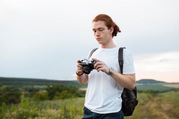 Medium shot man holding camera