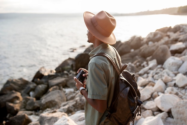 Free photo medium shot man holding camera