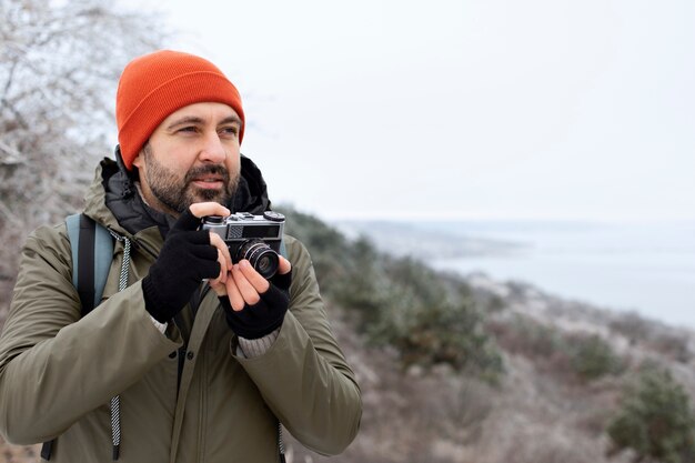 medium shot man holding camera