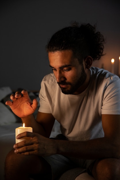 Free photo medium shot man holding candle