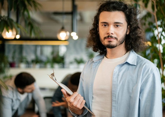 Medium shot man holding clipboard