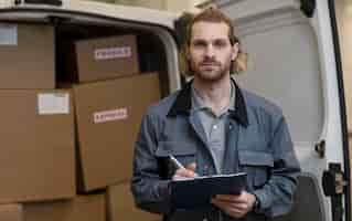 Free photo medium shot man holding clipboard