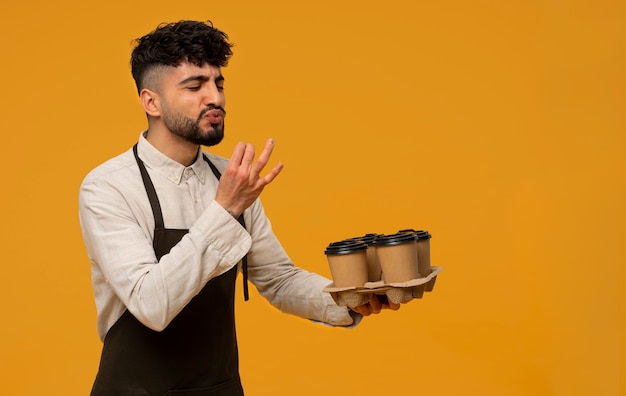 Free photo medium shot man holding coffee cups