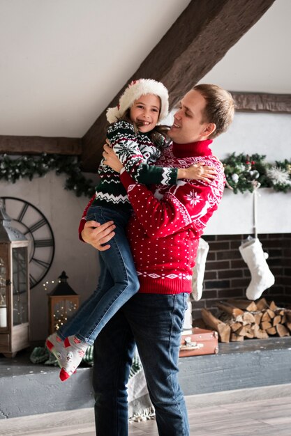 Medium shot man holding daughter