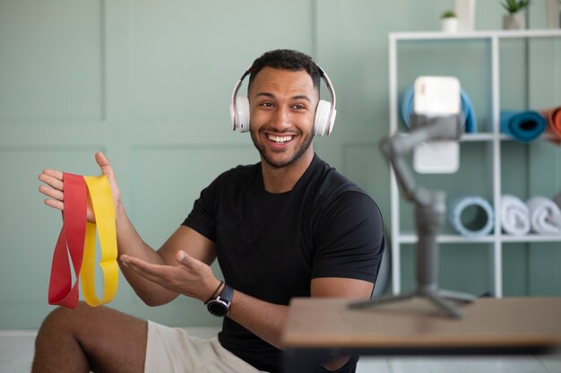 Medium shot man holding elastic bands