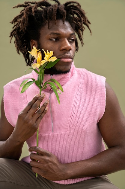 Medium shot man holding flower