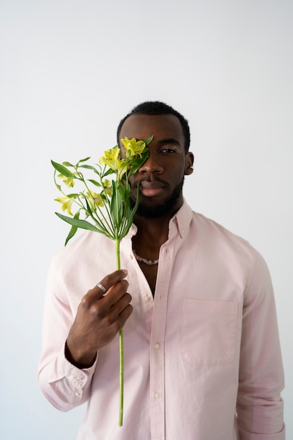 Medium shot man holding flowers
