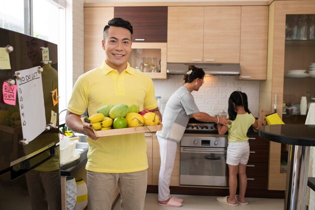 Medium shot man holding fruits plate