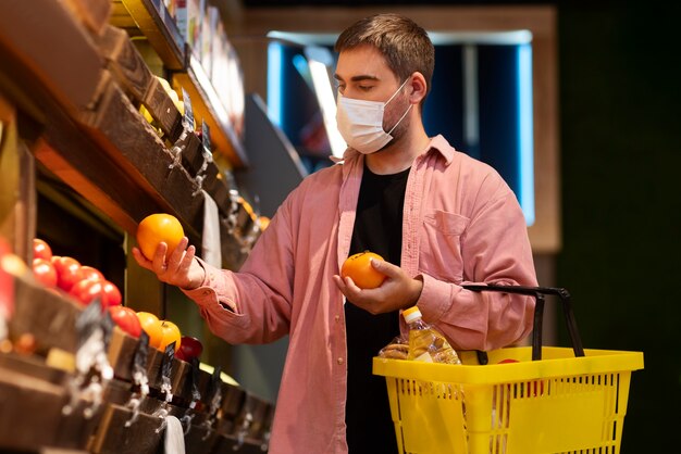 Medium shot man holding fruits