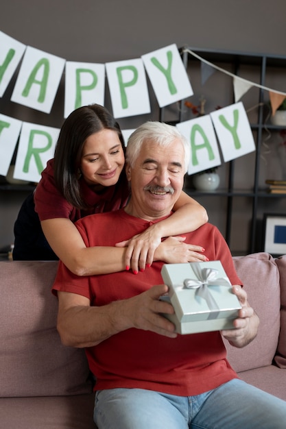 Free photo medium shot man holding gift