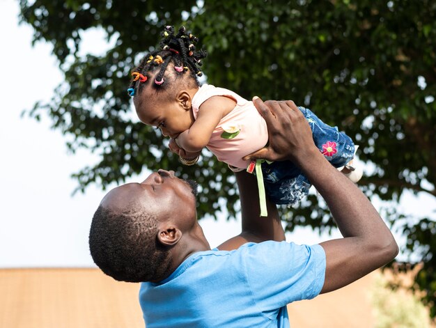 Medium shot man holding girl