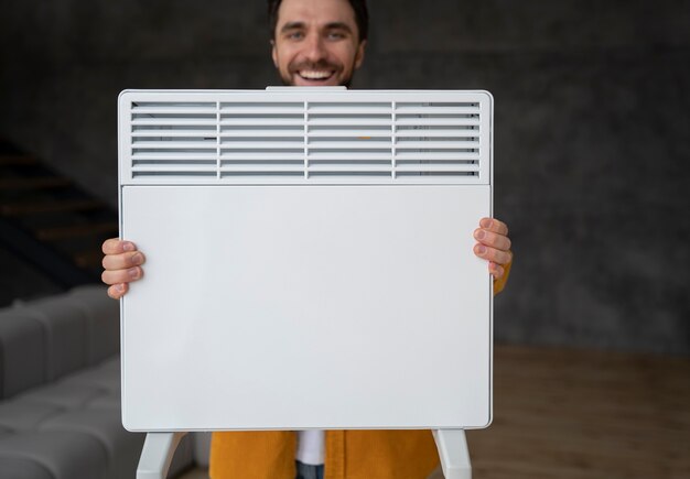 Medium shot man holding heater