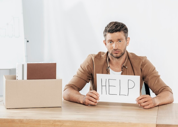 Medium shot man holding help sign