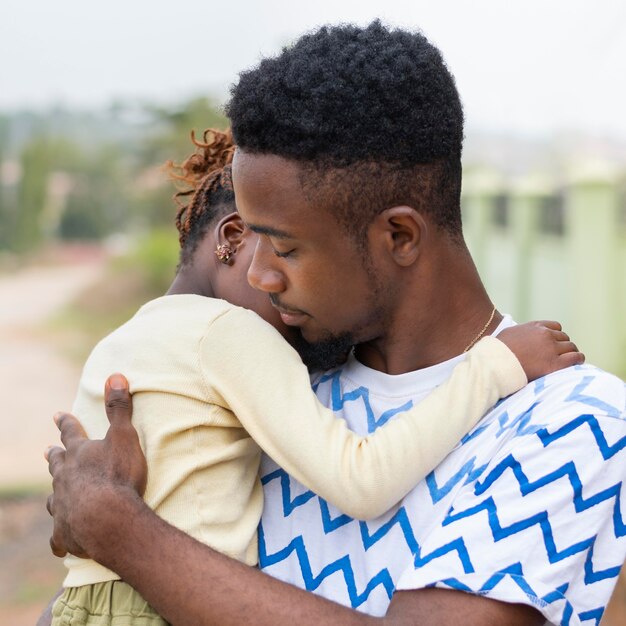 Medium shot man holding kid