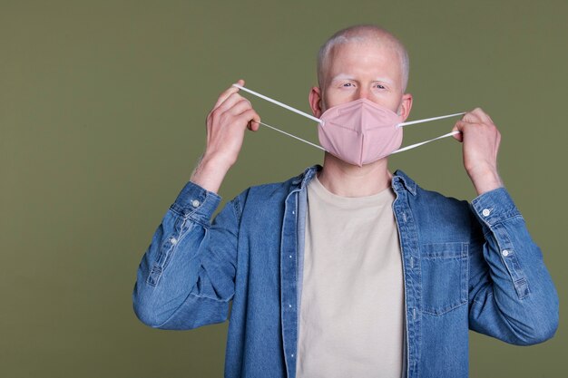 Medium shot man holding mask