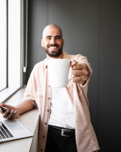 Medium shot man holding mug